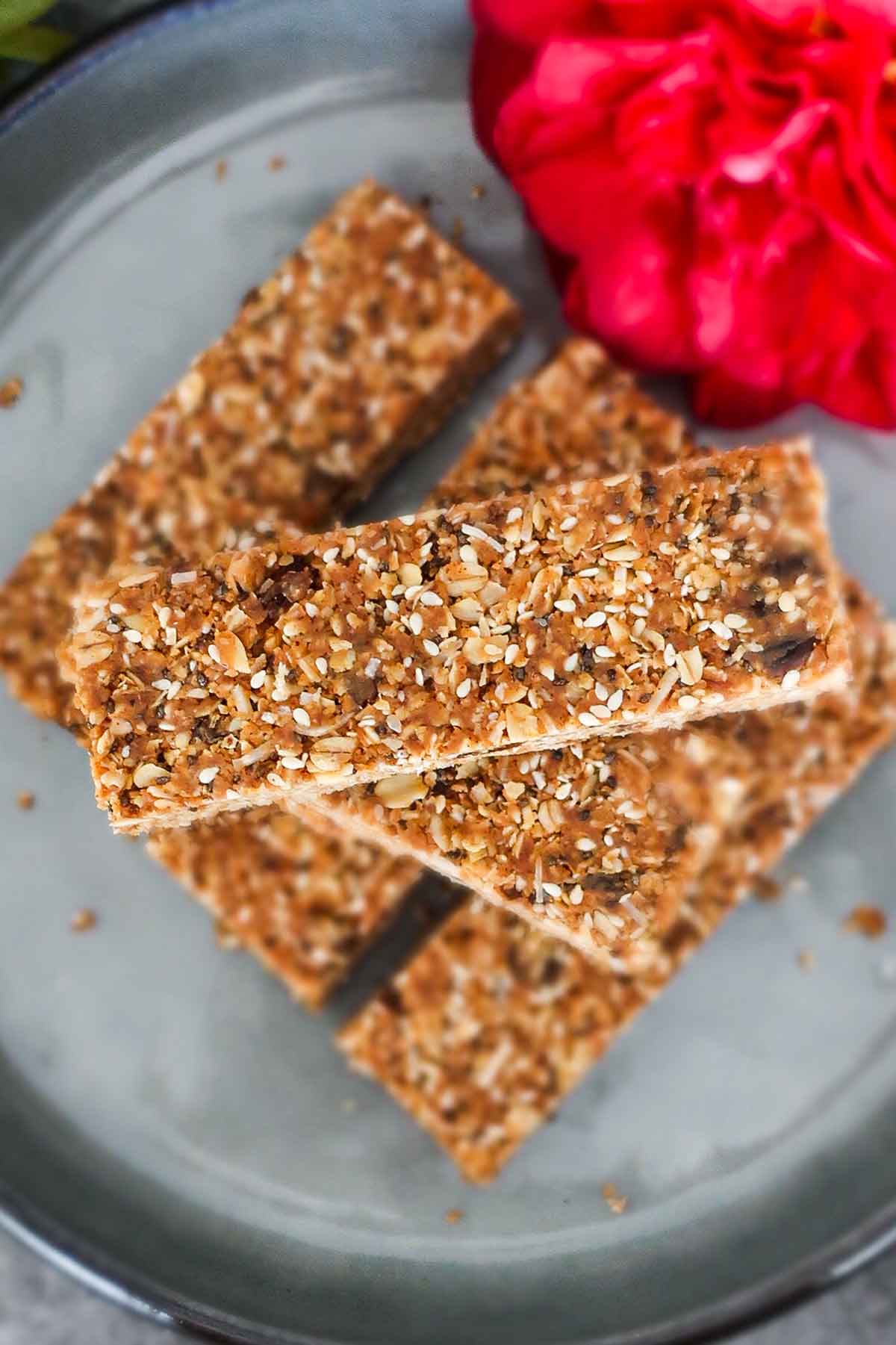 gluten free granola bars stacked on a plate with a rose
