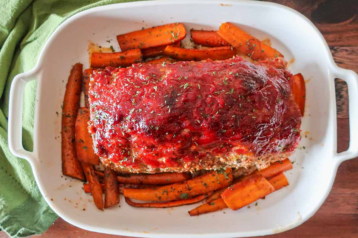 overview of baked meatloaf on a serving platter with carrots