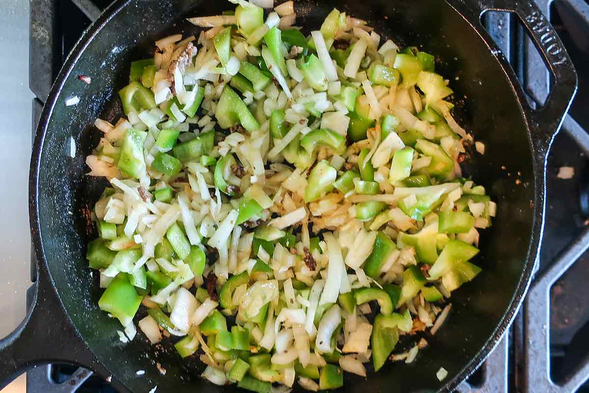 sauteing onions with green bell pepper in a skillet