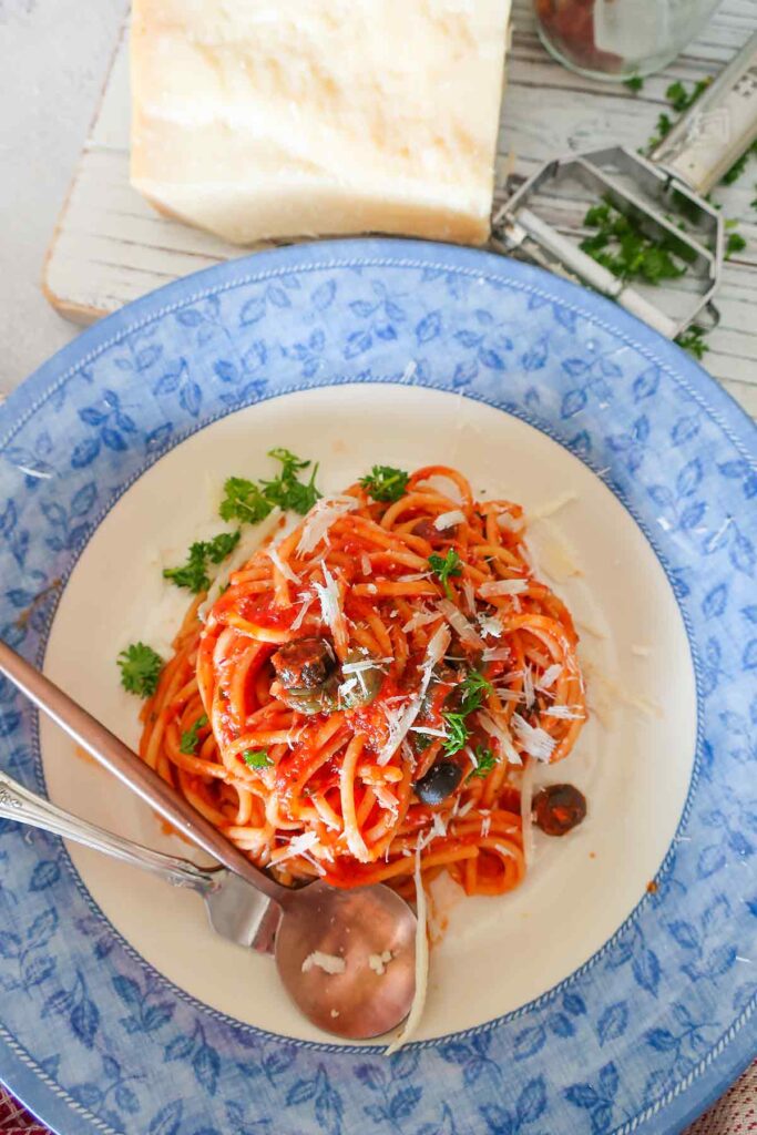 serving of gluten free pasta puttanesca in a deep plate