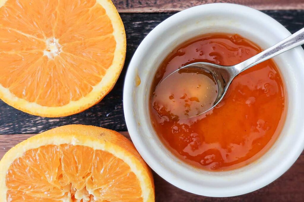 sliced orange and apricot jam in a bowl