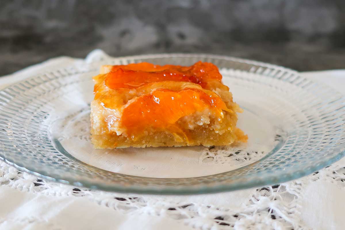 slice of apricot tart on a plate made with fresh June apricots