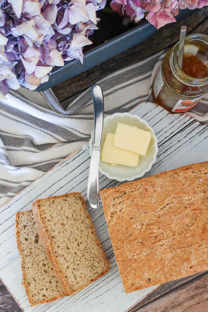 overview of sliced loaf of bread with a side of butter