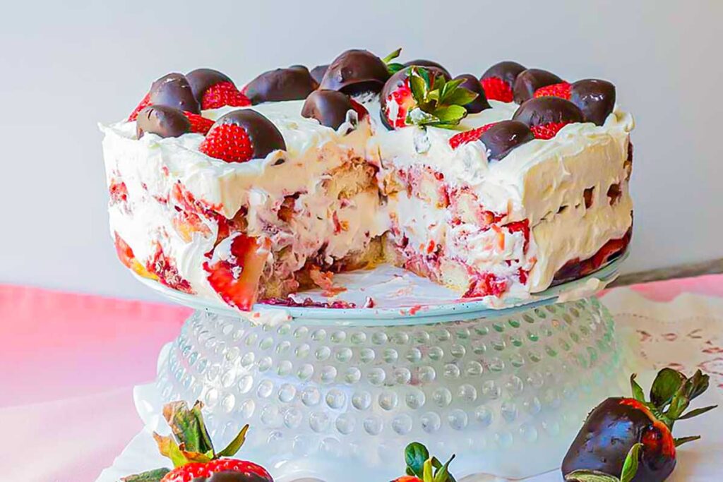 cross section of strawberry tiramisu dessert on a cake platter