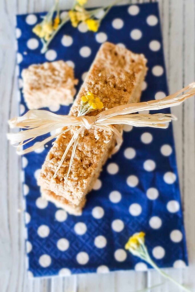 two maple shortbread oat bars tied with a string on a napking
