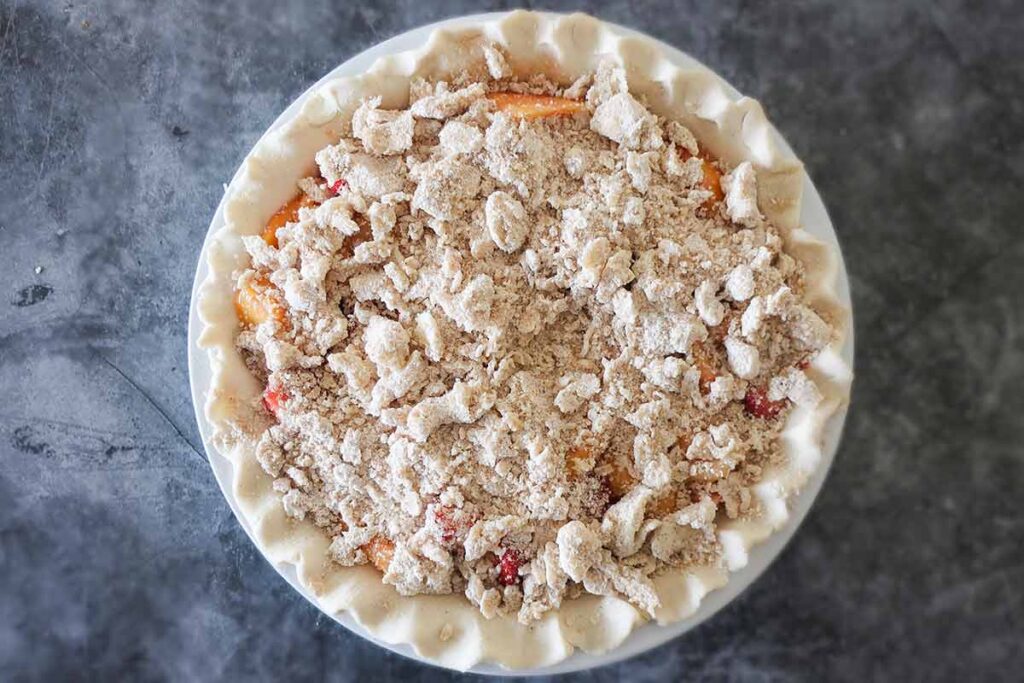 whole uncooked peach and strawberry pie