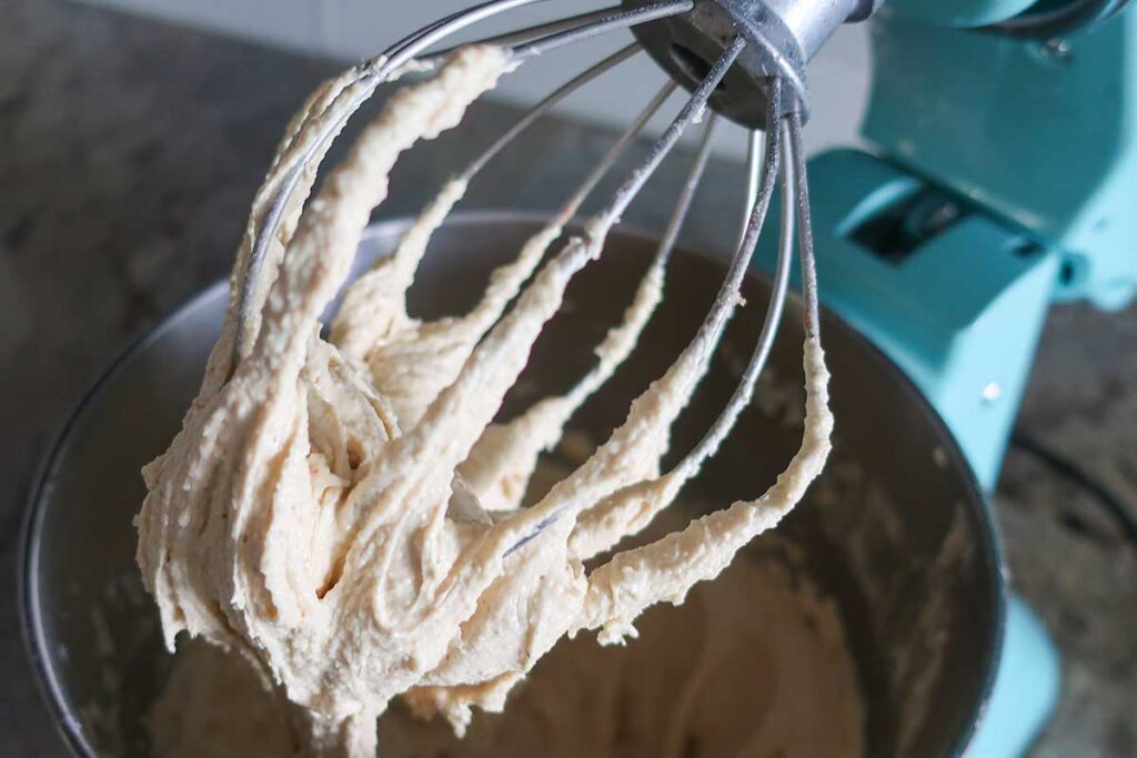 gluten free cake batter on a whisk