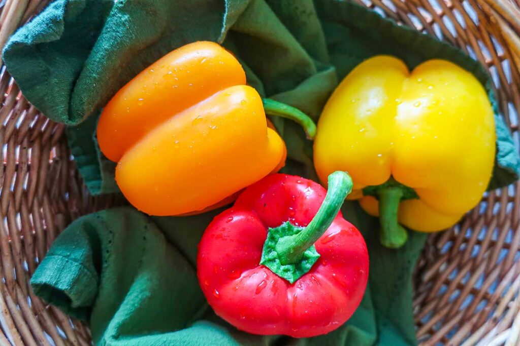 3 bell bell peppers in a basked