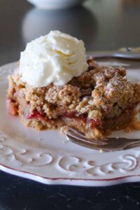 slice of gluten free breakfast cardamom plum cake topped with ice cream