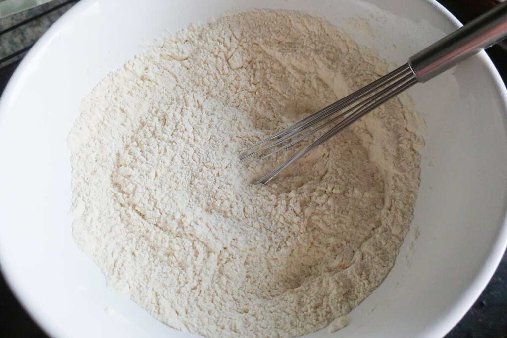 flour mixture in a bowl with a whisk