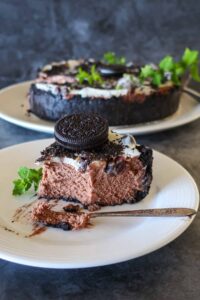 slice of tripple chocolate oreo cookie cheesecake on a plate