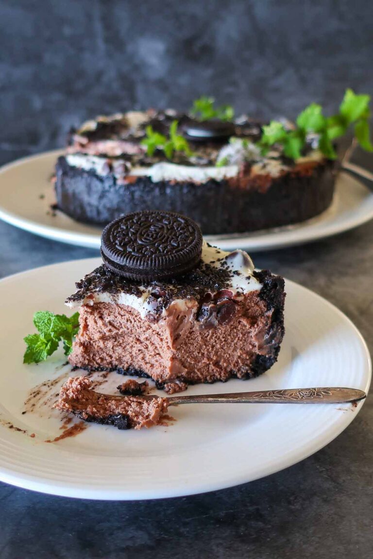 slice of tripple chocolate oreo cookie cheesecake on a plate showing smooth texture