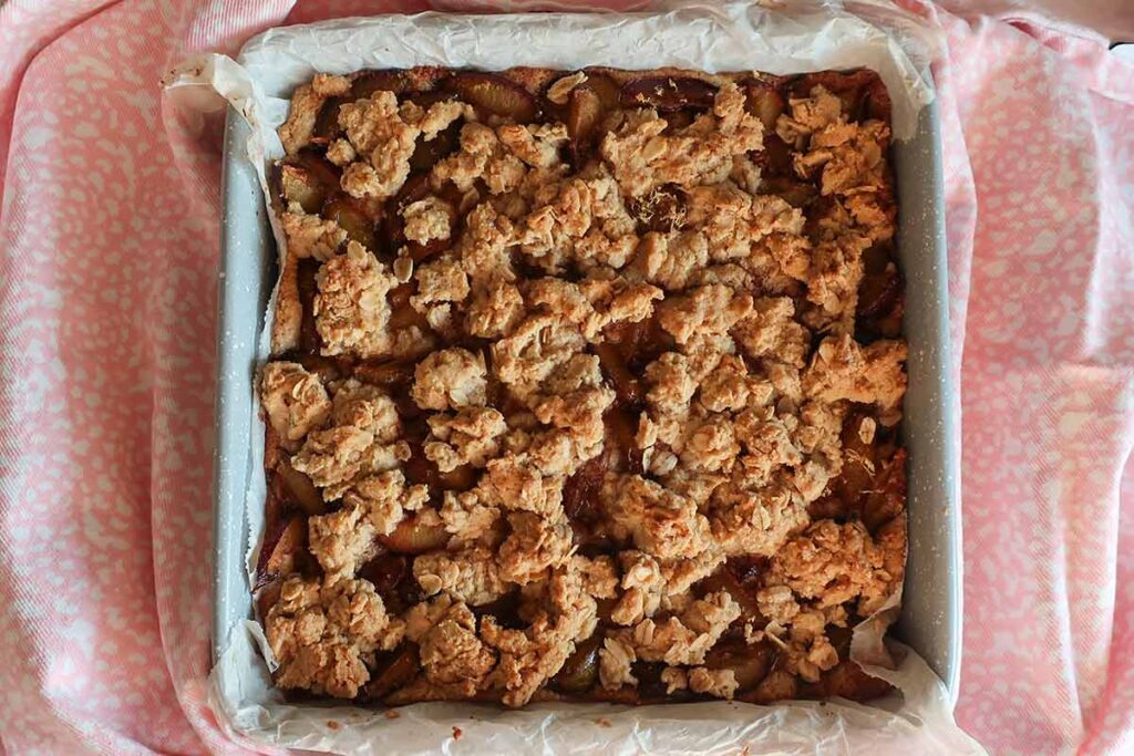 baked breakfast cardamom plum cake in a pan