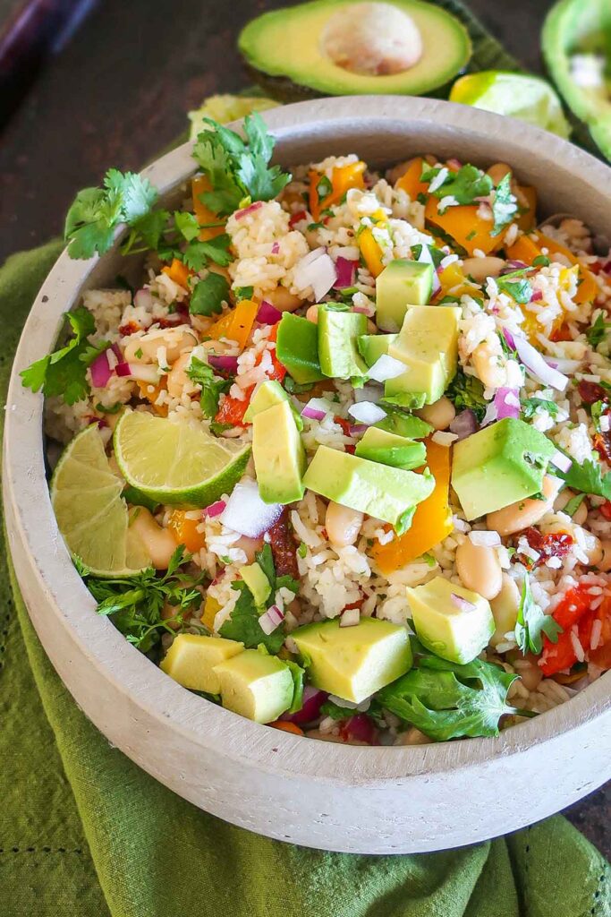 close up of roasted pepper white bean rice salad in a bowl