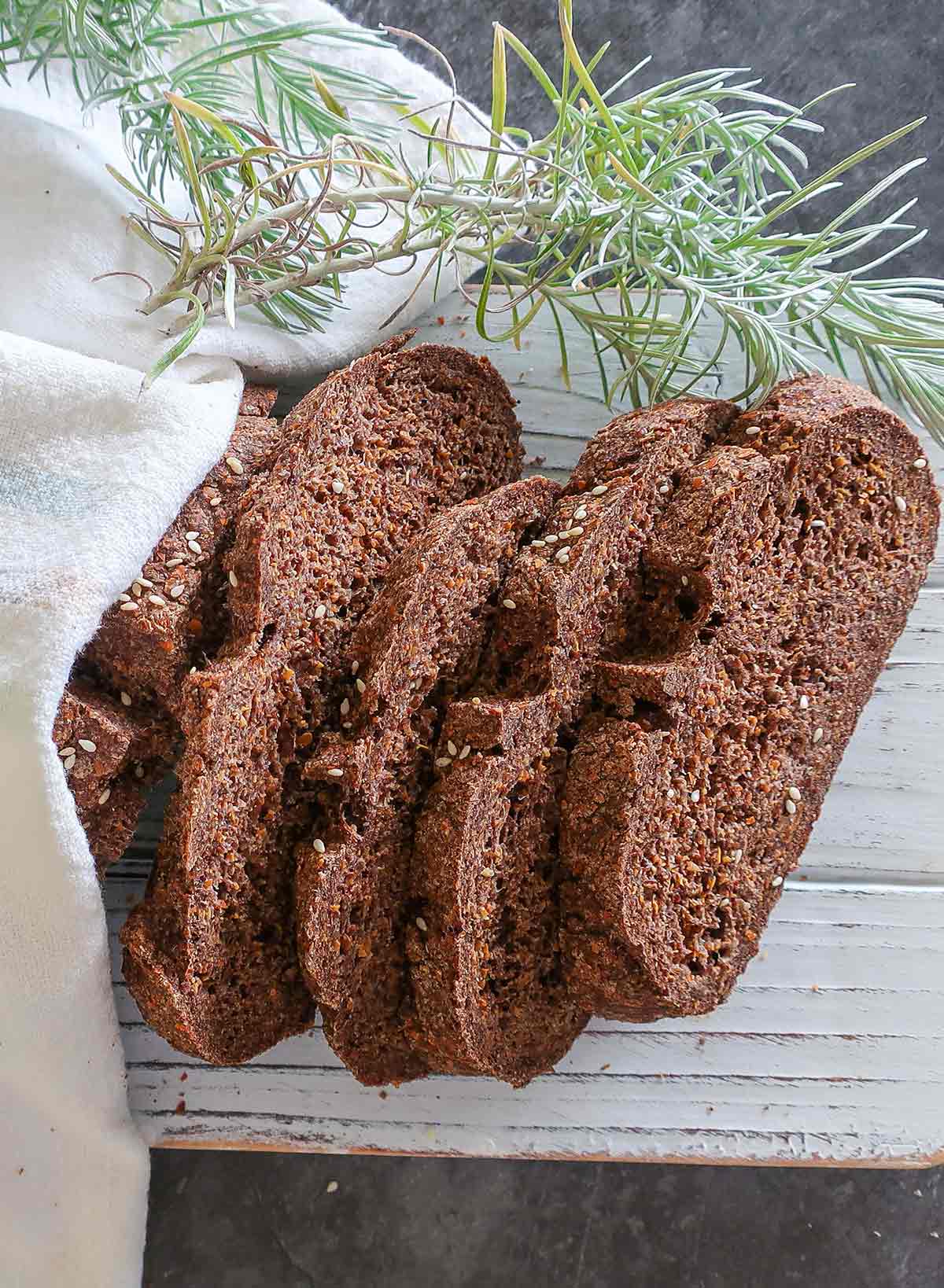 4 slices of flaxseed bread on a cutting board