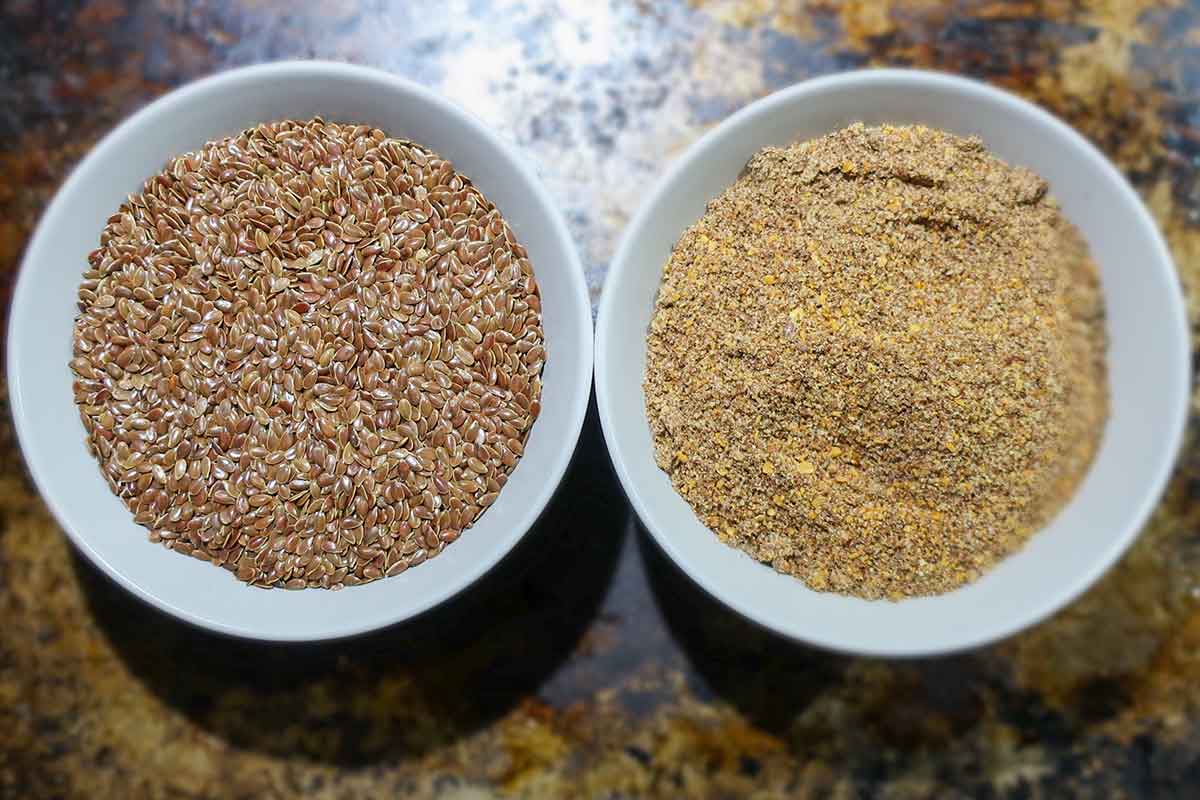 ground and whole flaxseeds in two bowls