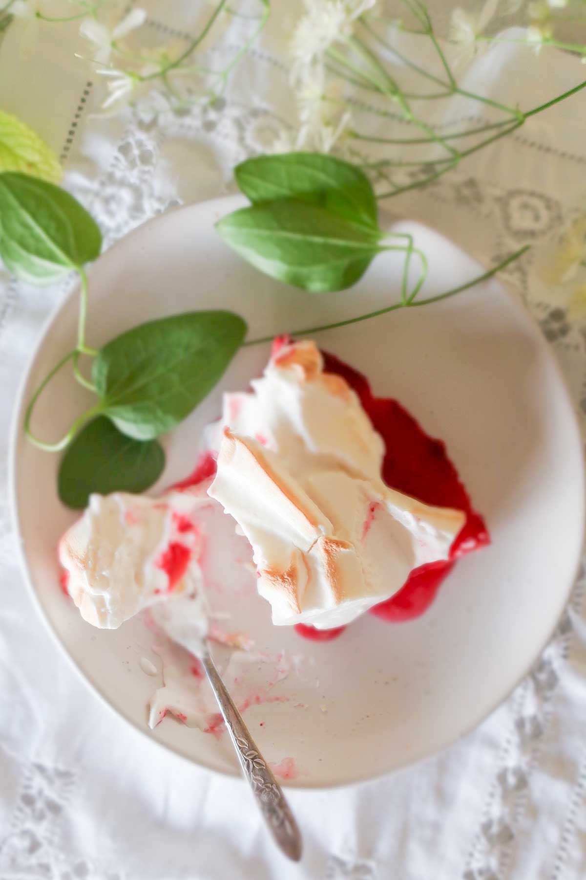 slice of lemon cranberry meringue cake on a dessert plate 
