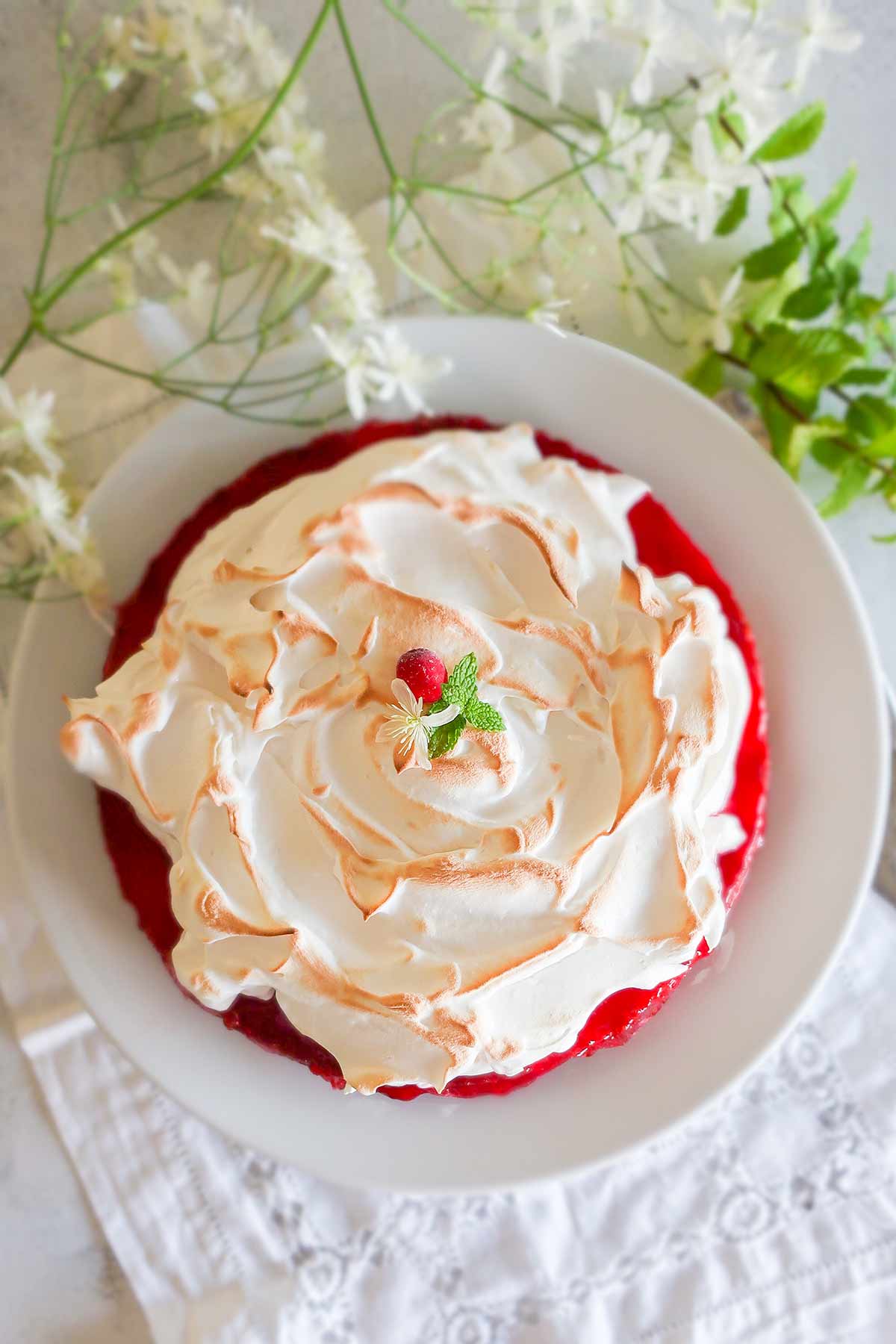 overview of lemon cranberry meringue cake on a platter