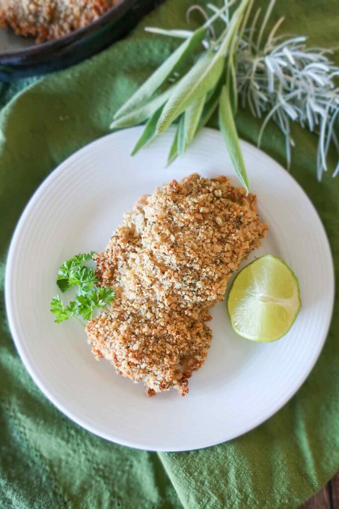 one piece of crispy oven-fried chicken on a plate