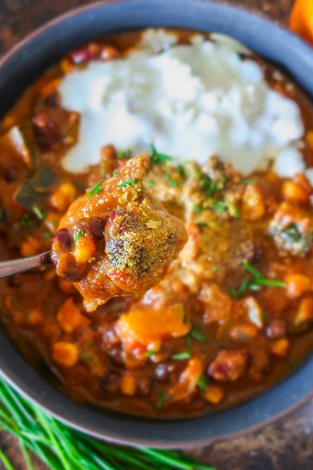 close up of pumpkin chili on a spoon