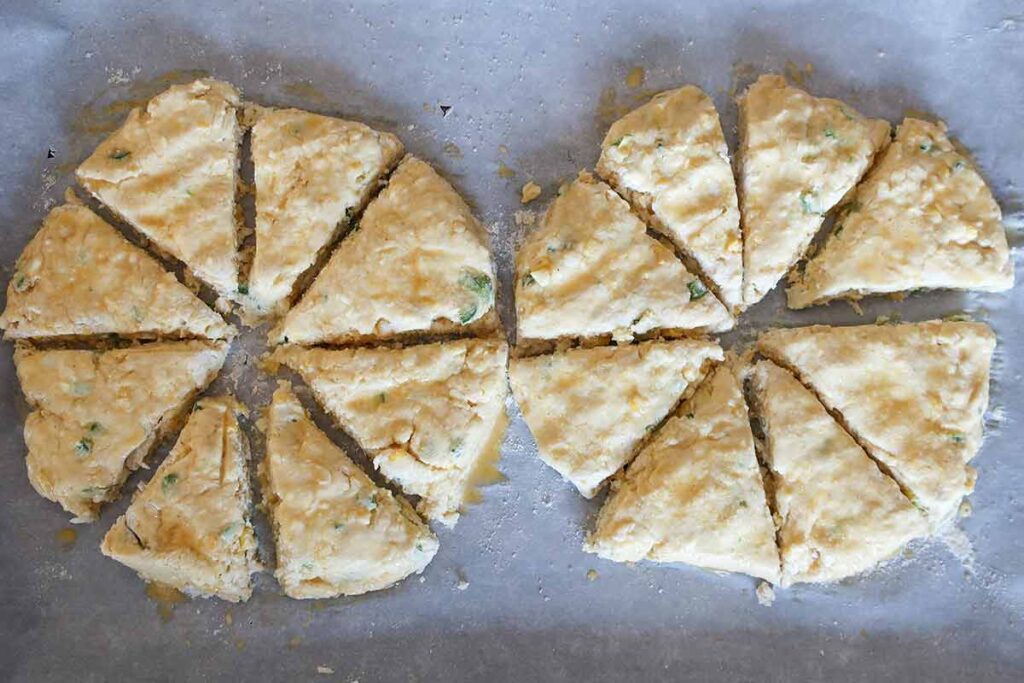 two disks of scone dough cut into wedges