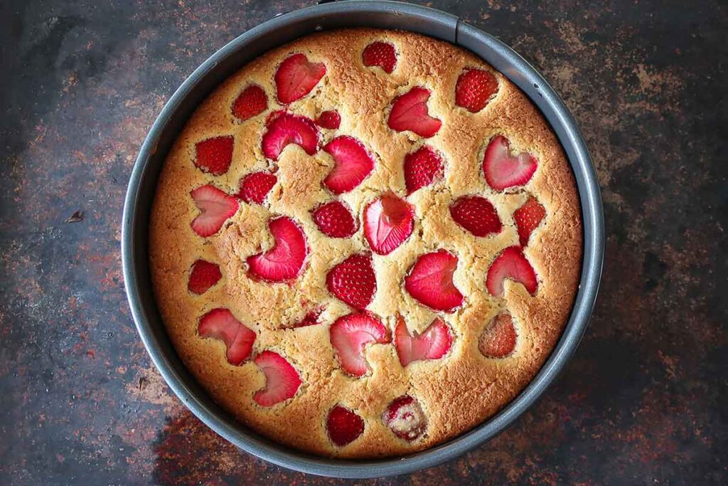 overview of baked strawberry buttermilk strawberry cake in a springform pan