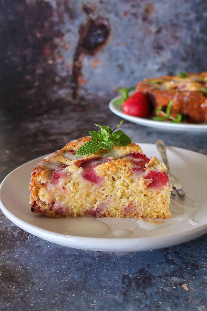 slice of strawberry buttermilk cake on a plate