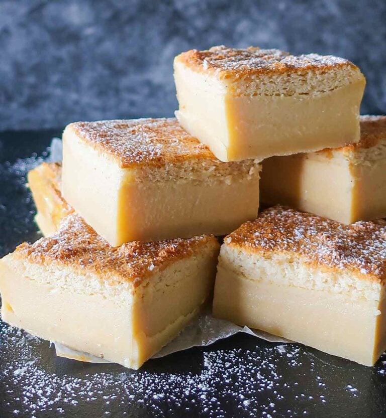 stacked slices of Gluten-free vanilla custard magic cake showing three distinct layers