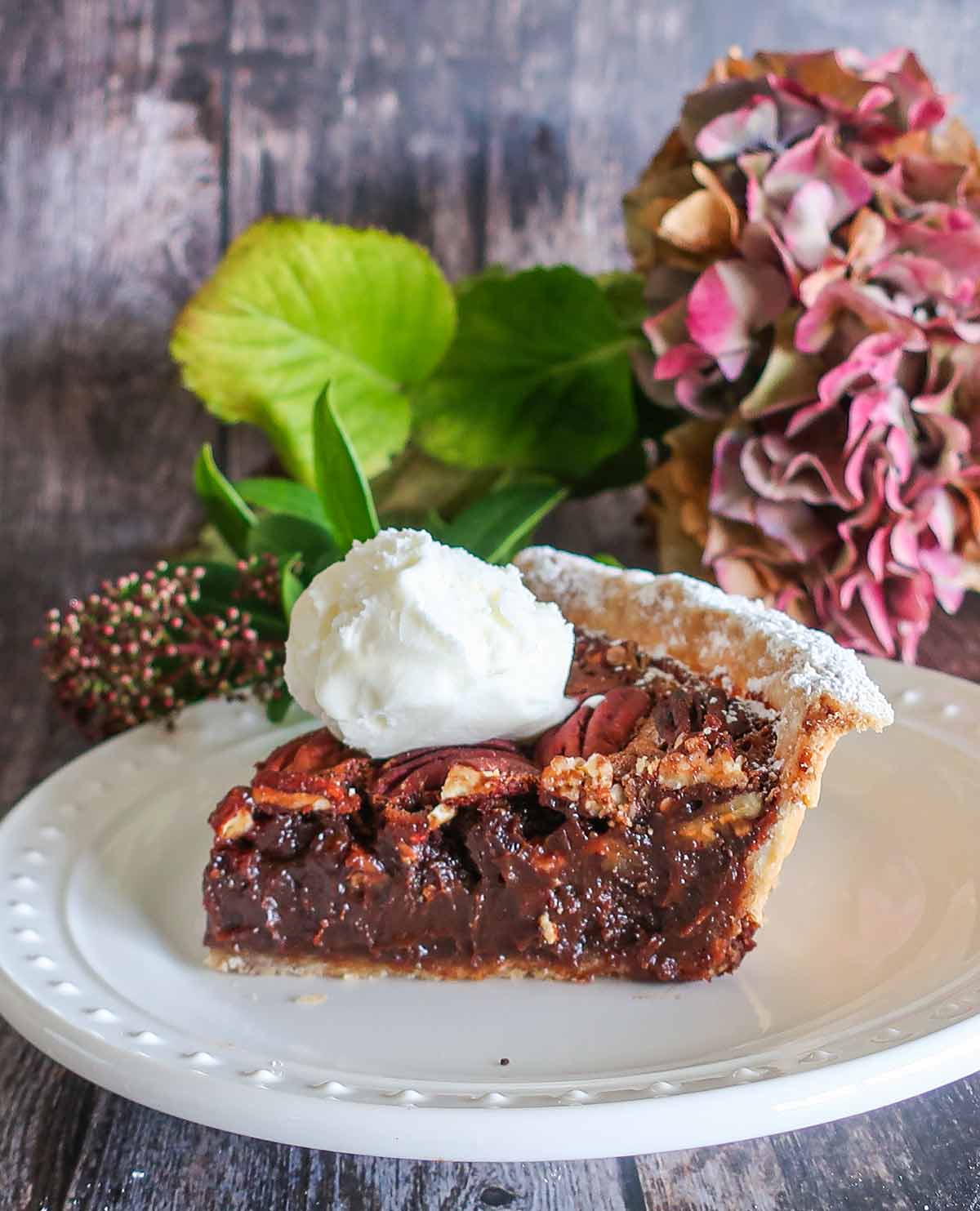 chocolate pecan pie with a scoop of ice cream