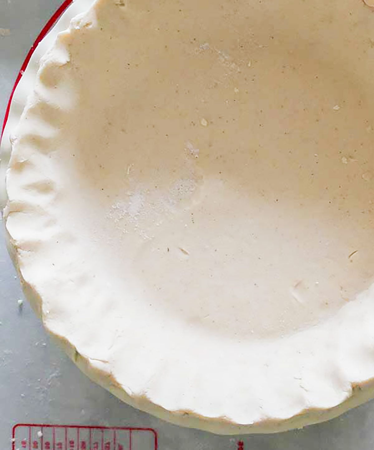 food processor pie crust showing smooth dough fluted in a pie dish