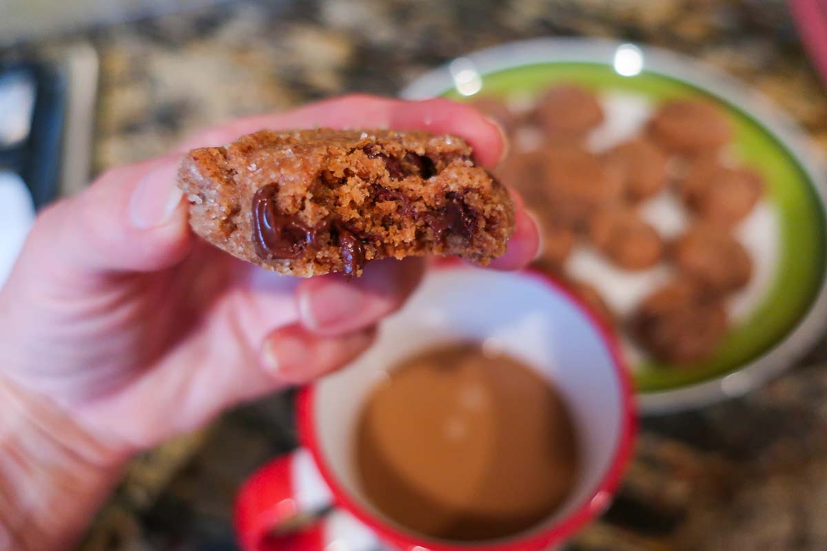 bite taken out of almond butter chocolate chip cookie