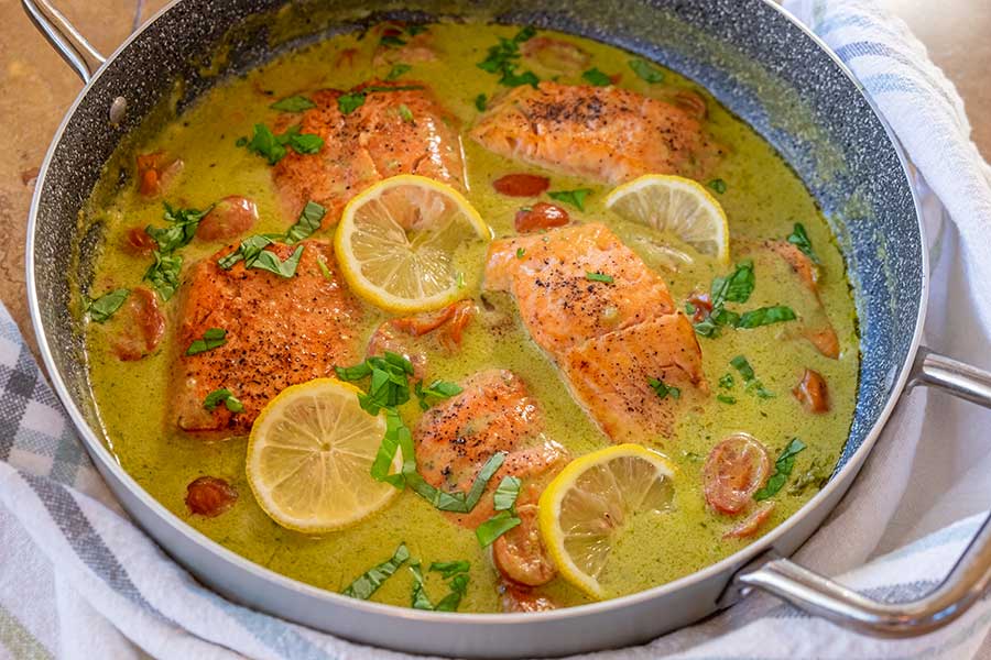 coconut pesto salmon in a skillet 