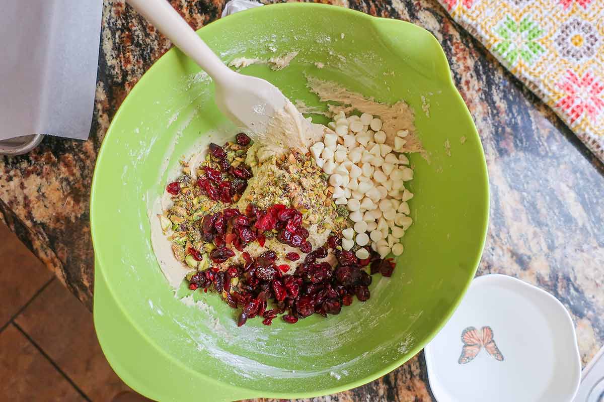 cookie dough, cranberries, pistachios and white chocolate chips in a bowl