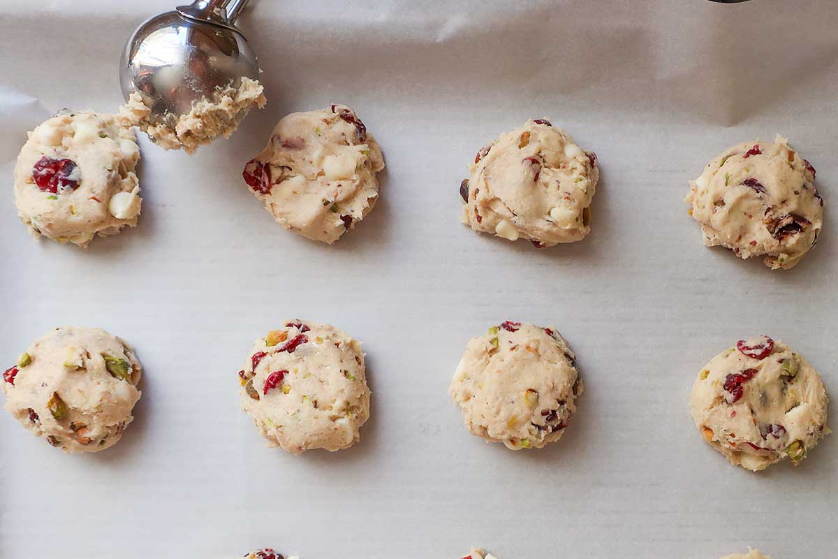 placing dough on a baking sheet with a cookie scoop