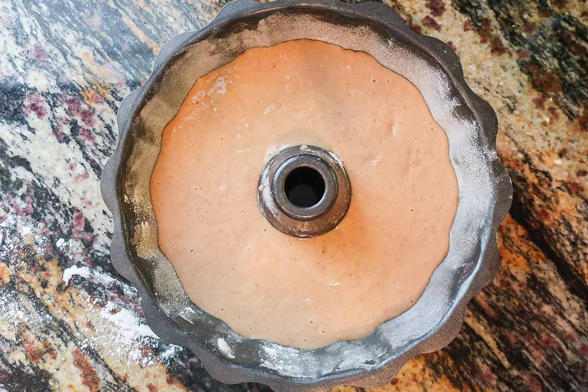 apple cider doughnut cake batter in a bundt pan