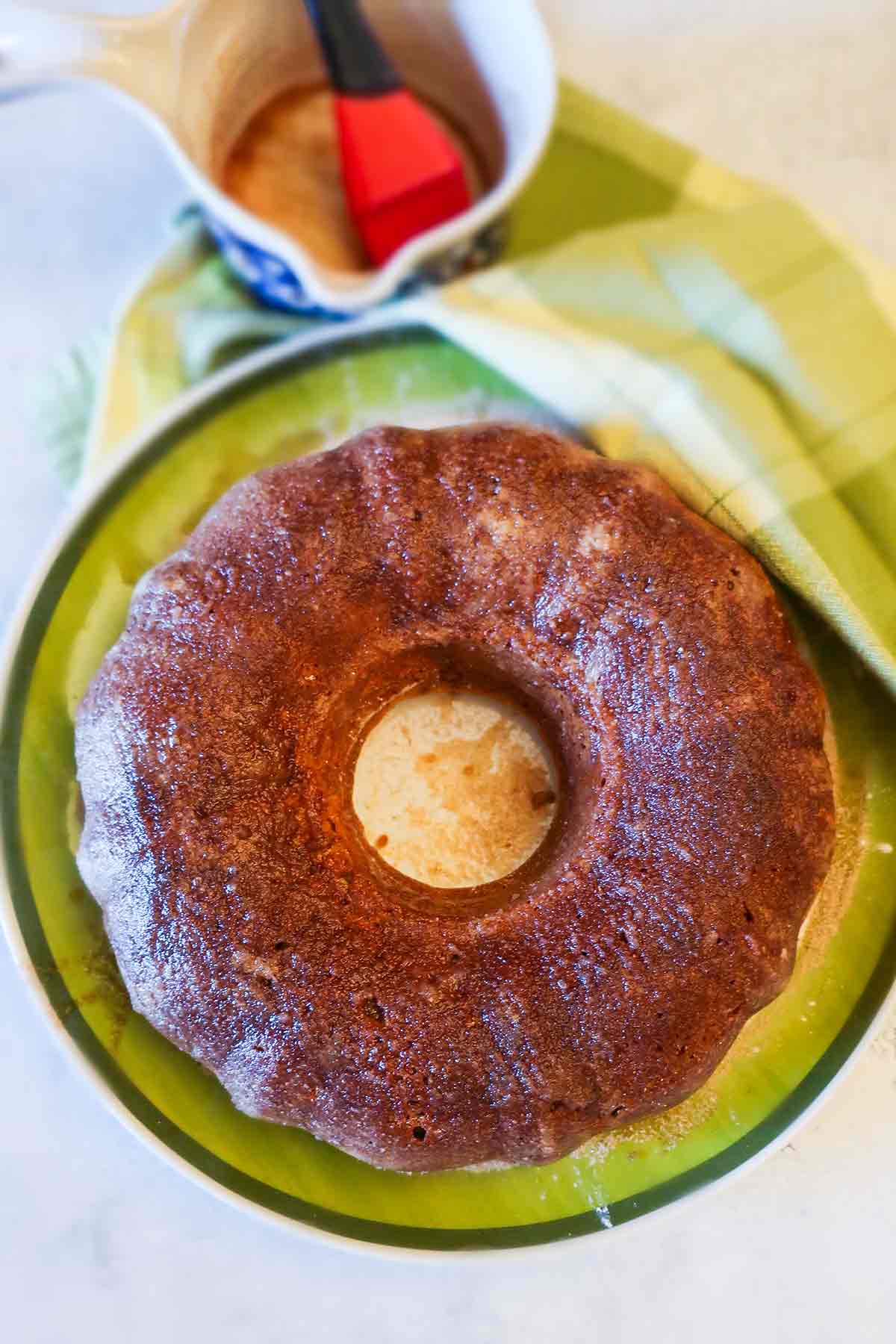 overview of baked apple cider doughnut cake on a plate