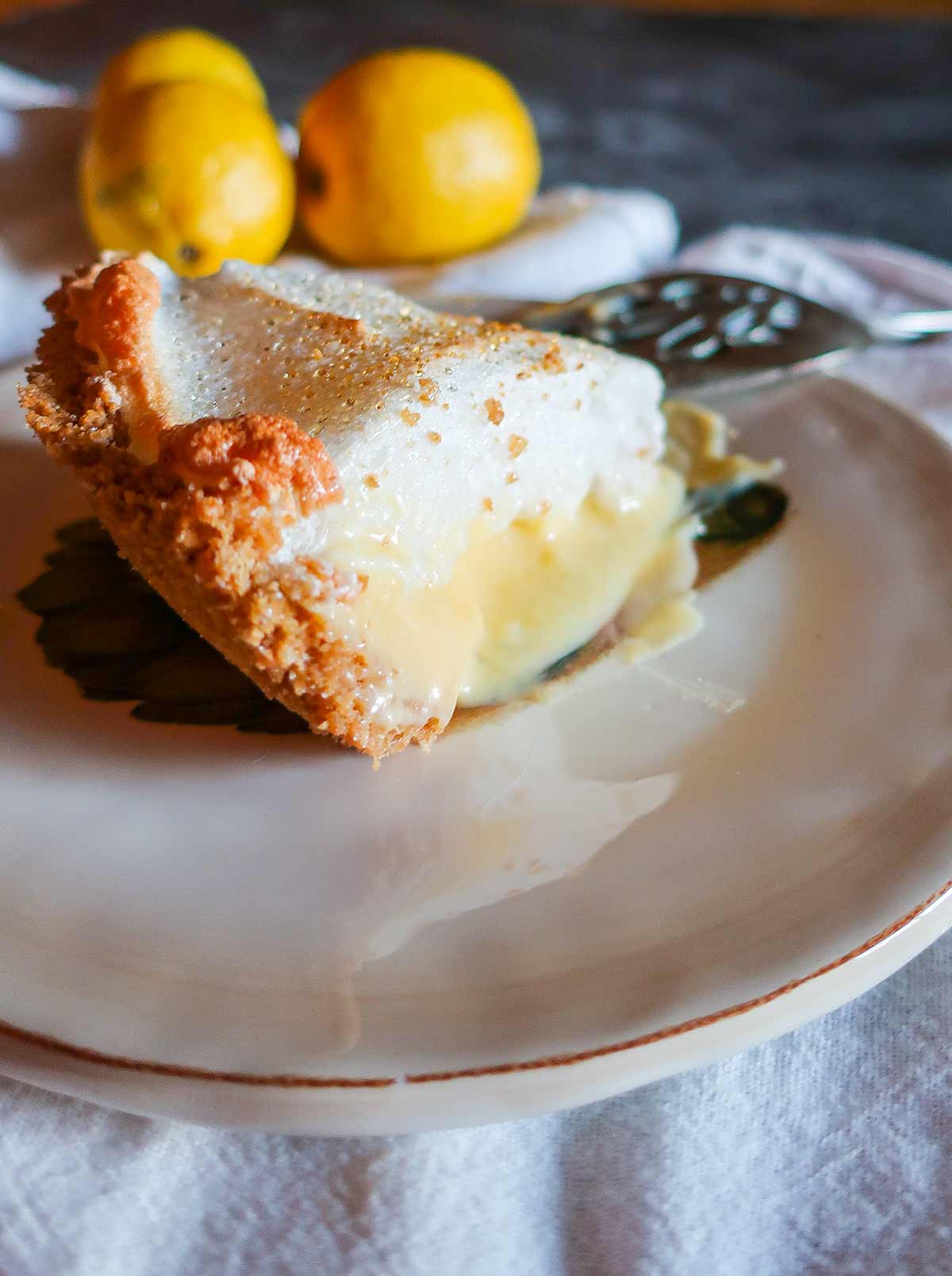 a slice of lemon. meringue pie on a plate