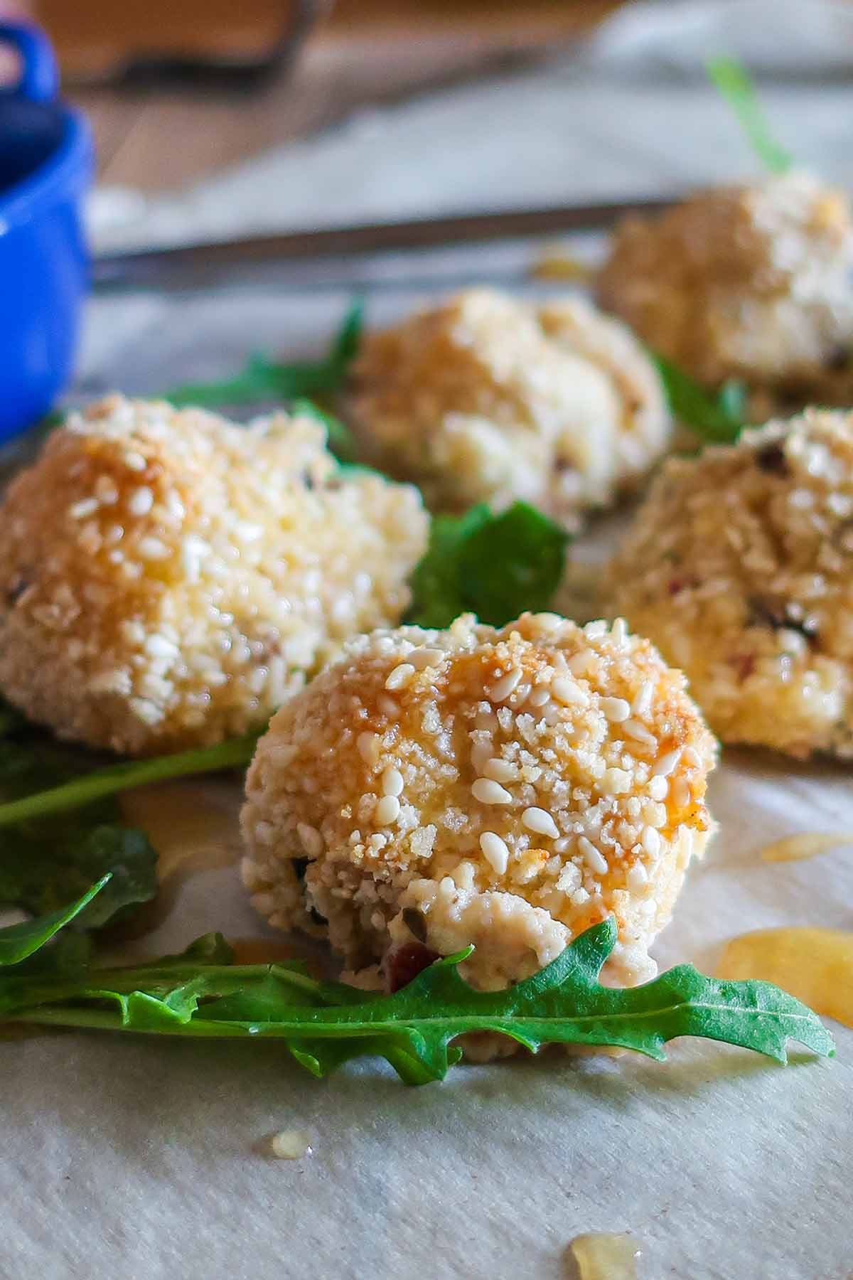 gluten free baked goat cheese and cranberry balls on greens