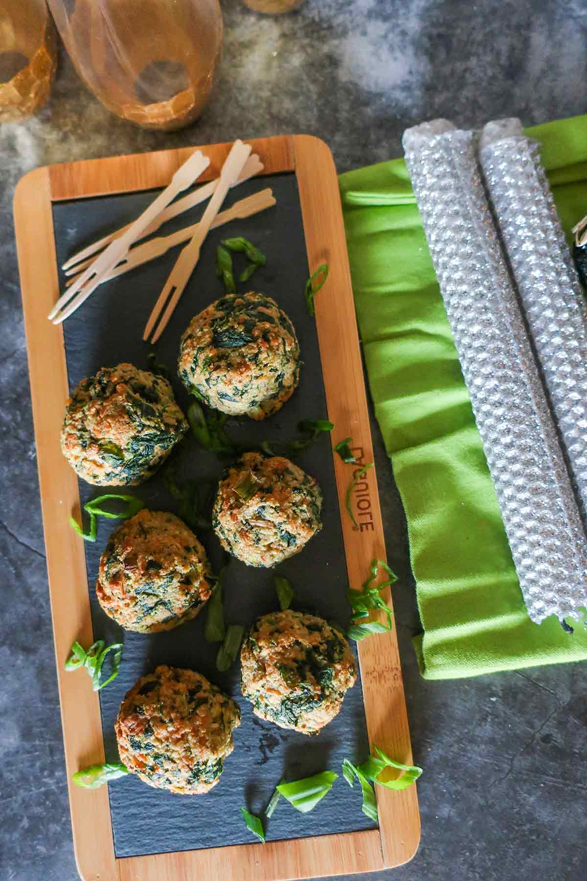 overview of savory spinach balls on a tray