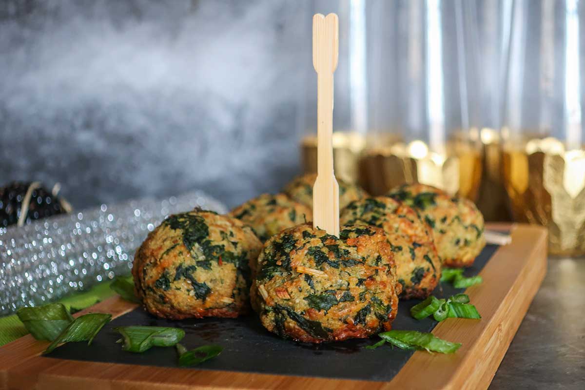 6 spinach balls on a wooden board