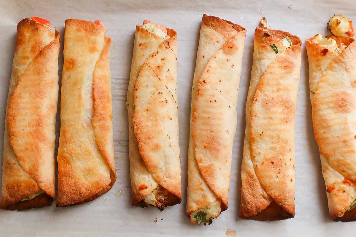 baked taquitos on a baking sheet