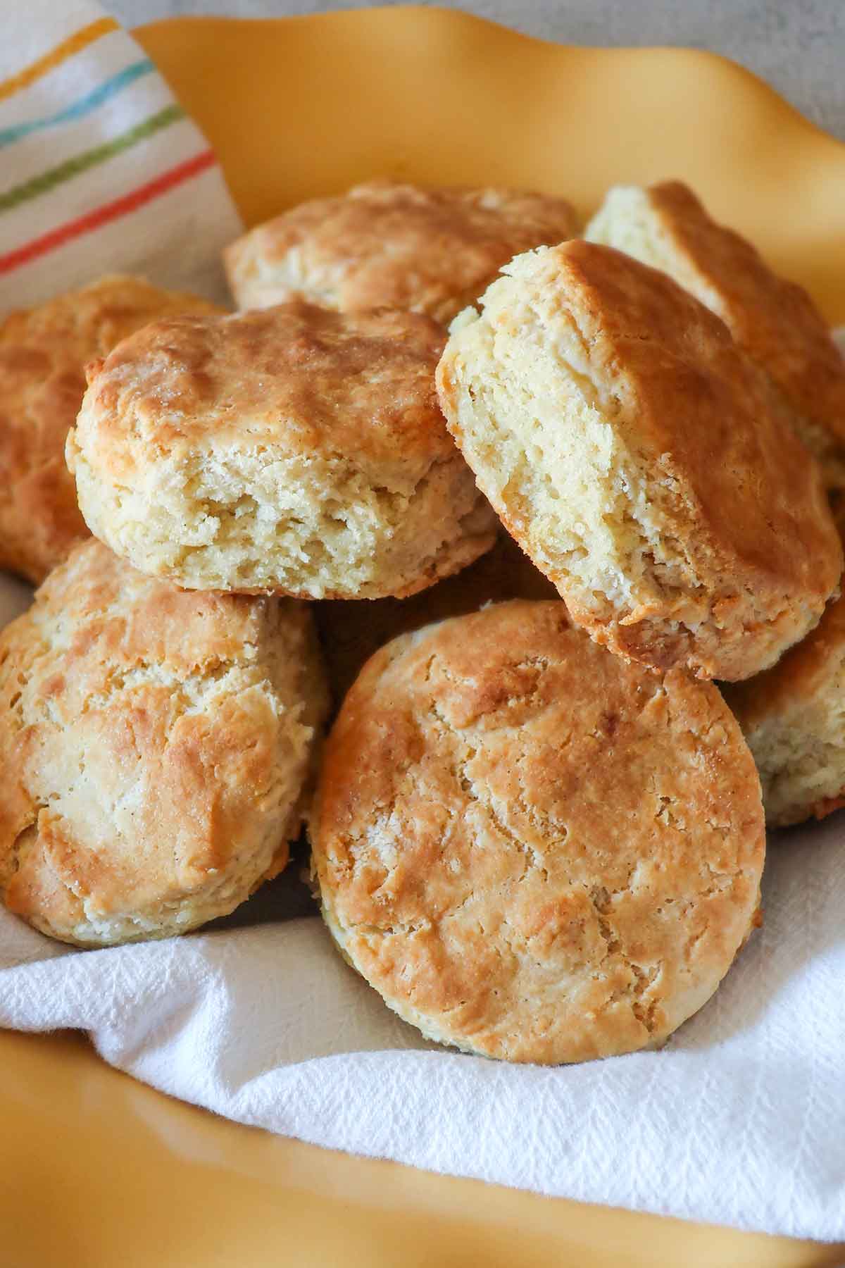 6 gluten free biscuits in a basket lined with kitchen towel