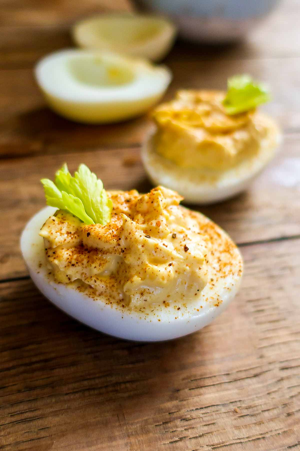close up of a deviled egg on a wooden board