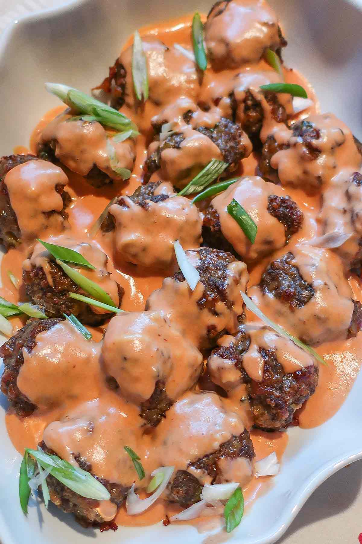 overview of gluten free Swedish meatballs with sauce and garnish