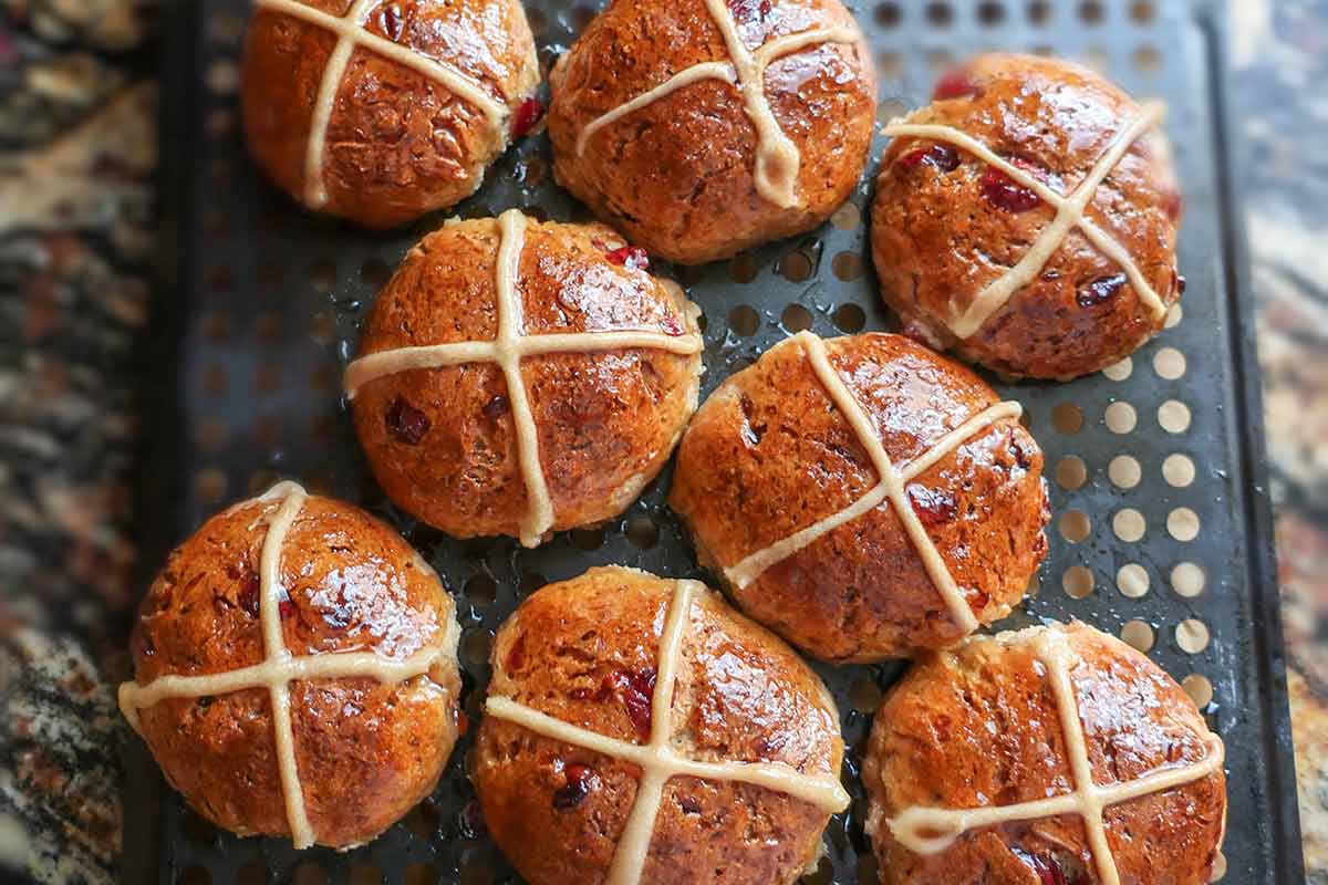 hot baked cross buns brushed with apricot glaze