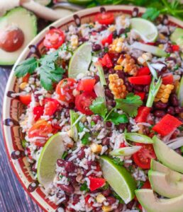 Southwest black bean rice salad in bowl with avocado slices