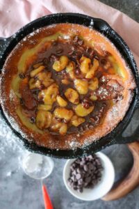 overview of Chocolate Banana Foster Dutch Baby in a skillet