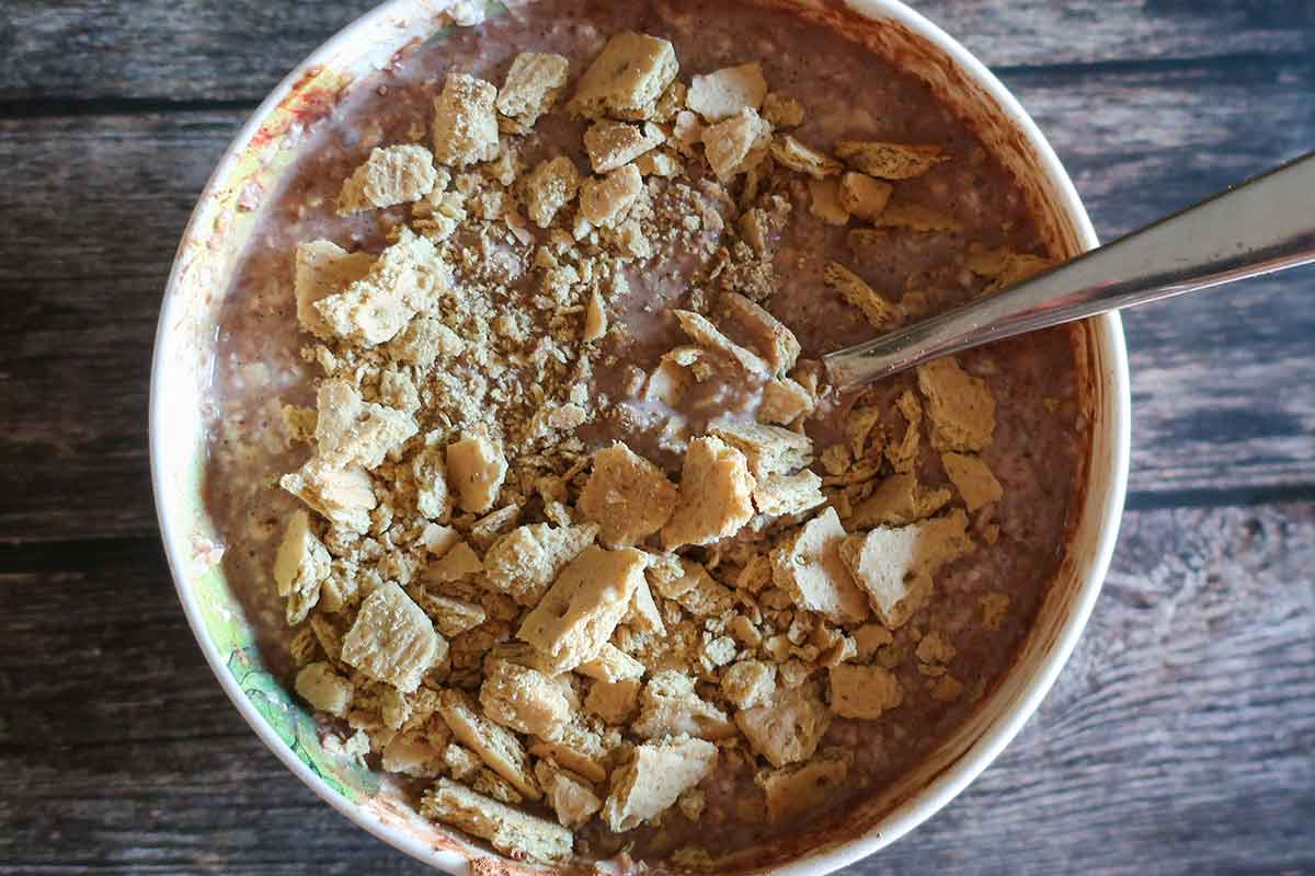 stirring crushed graham crackers into overnight oats