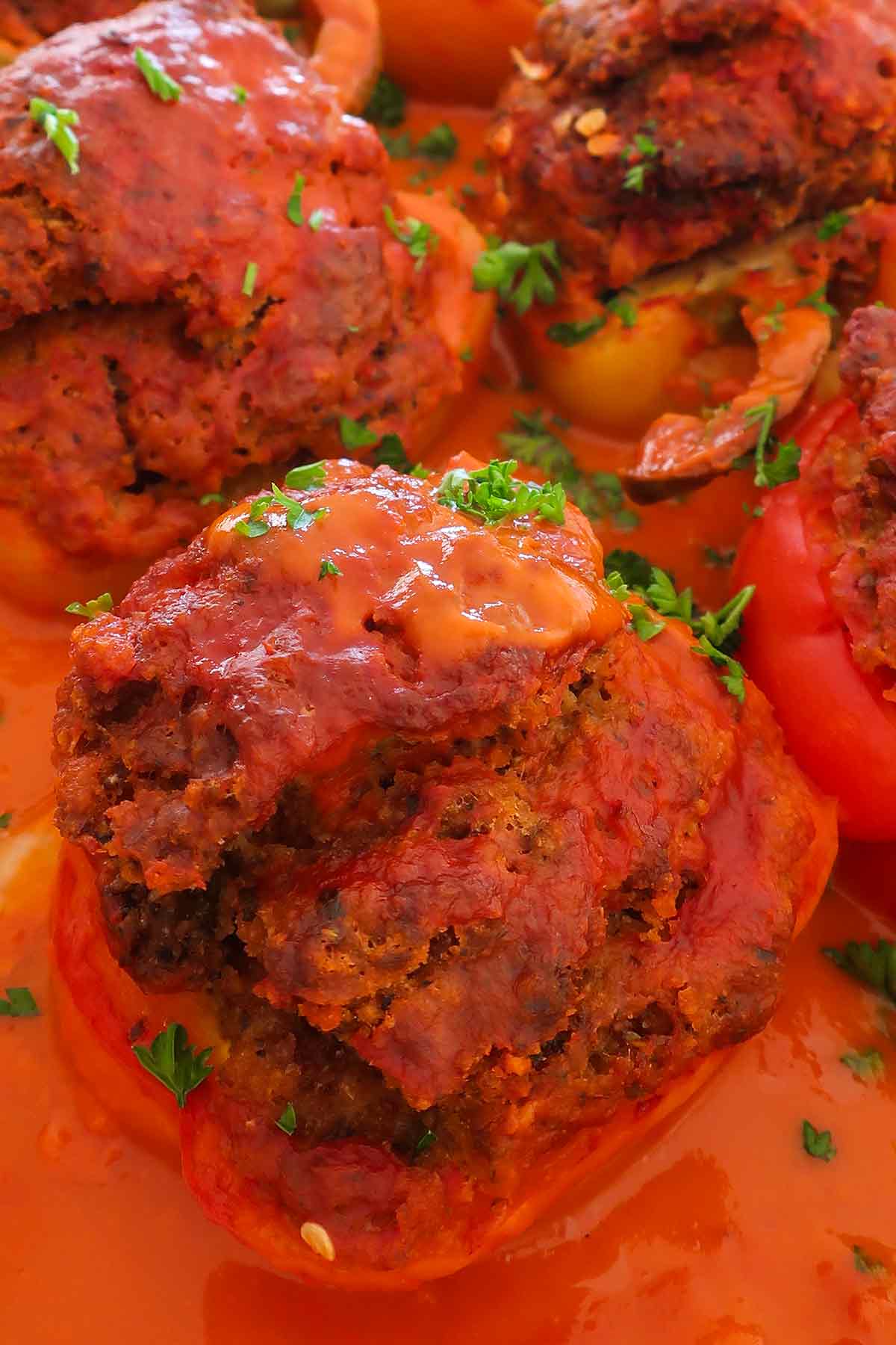one stuffed pepper with meat, sauce and garnish. of parsley