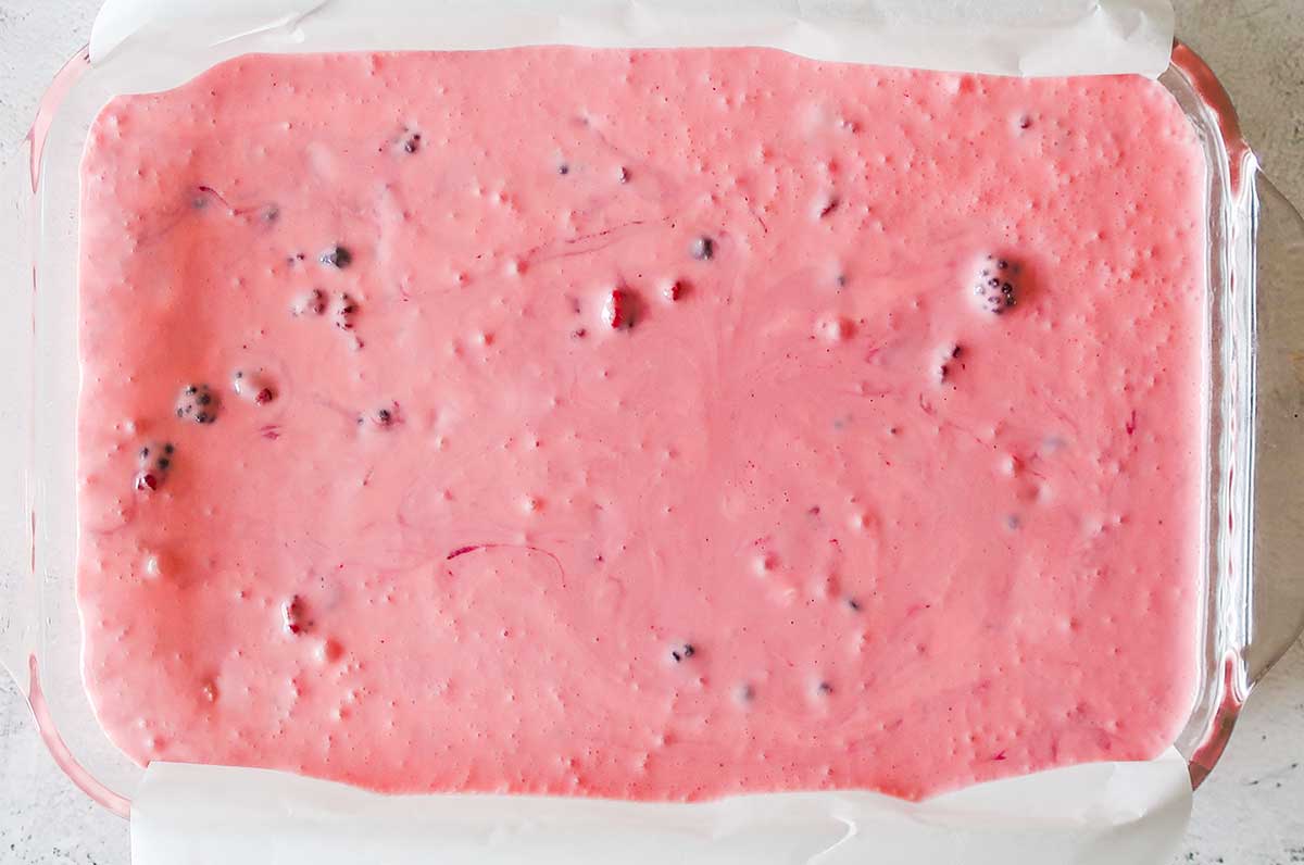 overview of berry cream bar filling before setting in a dish